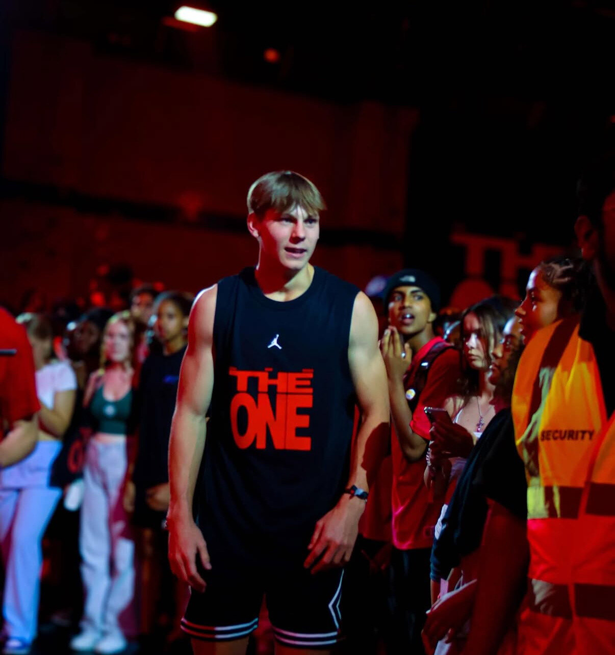 Cam Hazzard at an indoor dunk contest under red lights