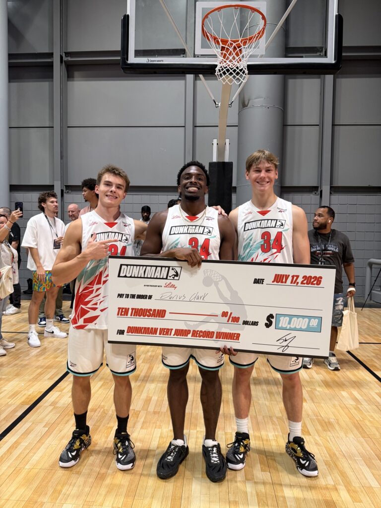 Cam Hazzard, Darius Clark, and Dillan McCarthy holding the $10,000 DUNKMAN Vert Jump Record Winner check at Fanatics Fest