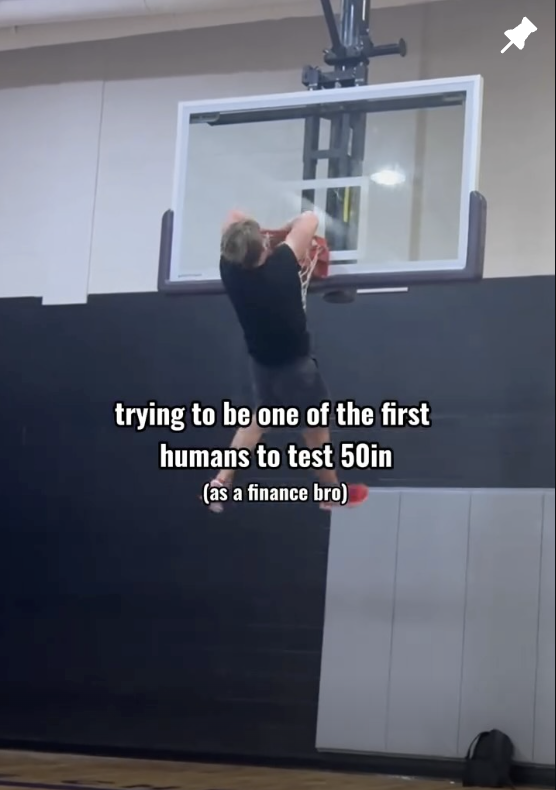 Cam Hazzard hanging on the rim testing a 50 inch vertical