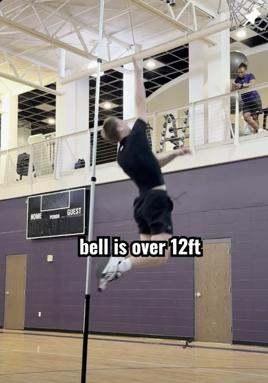Cam Hazzard jumping to touch a bell hung over 12 feet