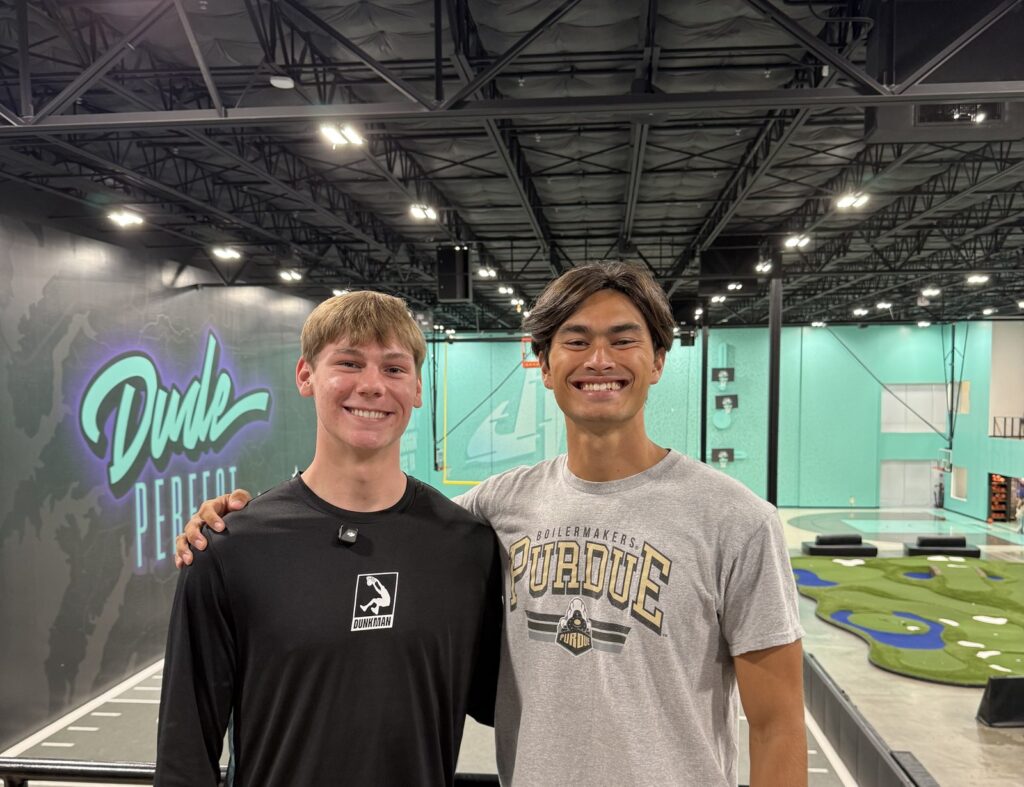 Cam Hazzard and a friend inside Dude Perfect headquarters